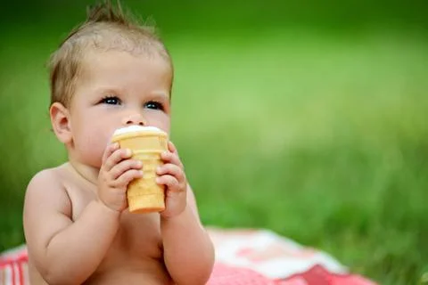 Little boy eats ice cream, a cute little one Stock Photos