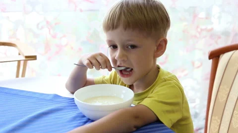 The little boy eats porridge Stock Footage 52430718