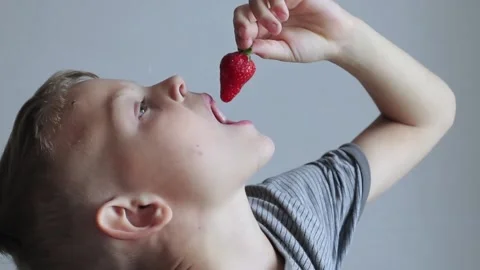 Little boy eats strawberries  at Home. Causal Lifestyle. Stock Footage 140730769