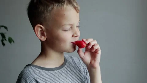 Little boy eats strawberries  at Home. Causal Lifestyle. Stock Footage 140730788