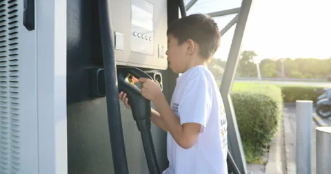 Little boy enjoy EV car charge station outdoor 스톡 동영상 314152853