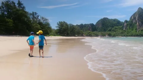 Little boy enjoying ocean, playing in waves, happy emotions during vacation Stock Footage 252035409