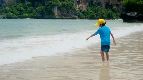 Little boy enjoying ocean, playing in waves, happy emotions during vacation Stock Footage 252035448