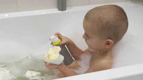Little Boy Enjoys a Relaxing Bubble Bath Stock Footage 301100494
