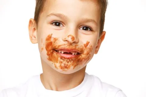 Little boy with face and hands in chocolate Stock Photos