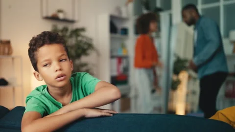 Little boy feeling upset because his parents keep fighting, unhappy family Stock Footage 254019948