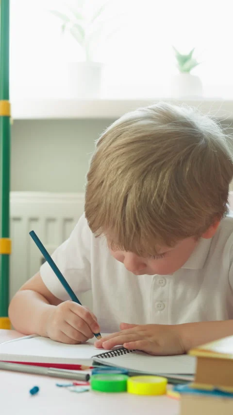 Little boy finds solution of difficult maths problem at desk Stock Footage 275079109