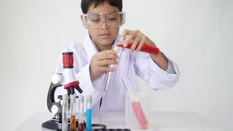 Little boy with flasks  and microscope equipment for chemistry science class Stockbeeldmateriaal 91804998