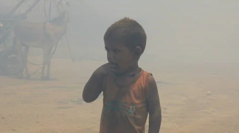Little Boy in Front of Burning Rubbish Dump Stock Footage 753653