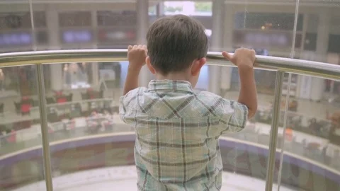 Little boy in a glass elevator cabin in shopping center Stock Footage 76961182