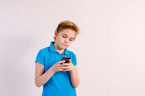 Little boy in glasses using a tablet computer with a light background Stock Photos