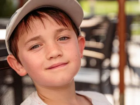 Little boy with gray baseball hat Stock Photos