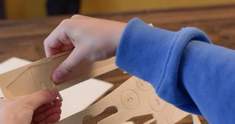 Little boy hands draw out airplane body part of plywood sheet Stock Footage 323971994