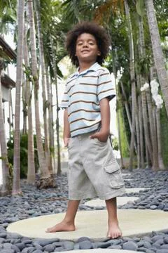 Little Boy With Hands In Pockets On Stepping Stone Stock Photos