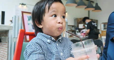 Little boy happy drinking ice sweet in cafe Stock Footage 135543537
