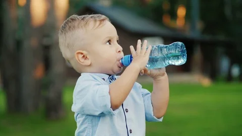The little boy has been drinking water from the bottle for 1 year. Standing in Stock Footage 80018534