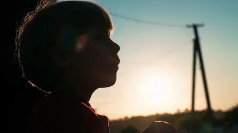 A little boy has dinner at sunset at a summer camp Stock Footage 200783472
