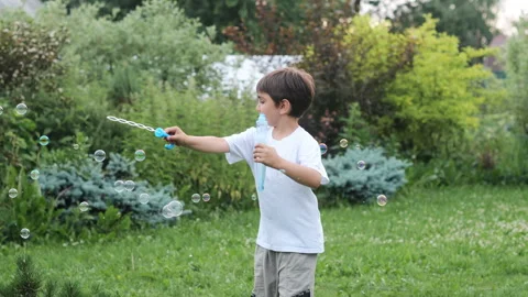 Little boy has fun playing with soap bubbles. Stock Footage 279407682