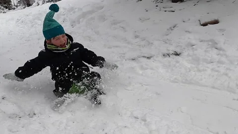 Little Boy Having a Blast Sledding (Slow-Mo Action Shot) Stock Footage 229310812