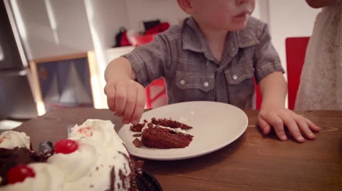 Little boy having a cake at table Stock Footage 64454112