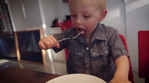 Little boy having cake at table Stock Footage 64454230