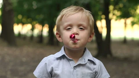 Little boy having fun and blows a party horn. Stock Footage 85982189