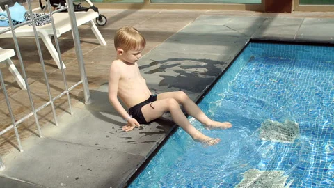 Little boy having fun in the pool in the summer. Slow motion. Stock Footage 120107027