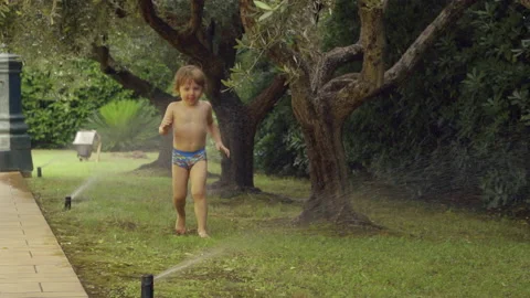 Little boy having fun with sprinkles. Candid moment of toddler boy having fun wi Stock Footage 134387257