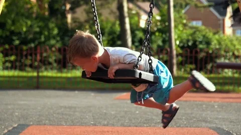 Little Boy having fun on the swing Stock Footage 79976266