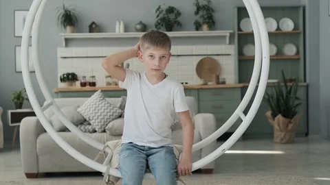 Little boy having fun on swing in living room. Happy son playing in slow motion Vídeo Stock 107069810