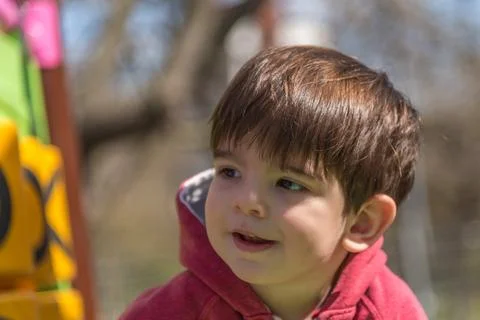 Little boy having fun while playing in an outdoor playground. Stock Photos
