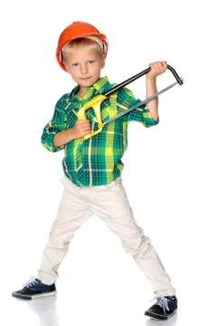 The little boy in the helmet of the builder. Stock Photos