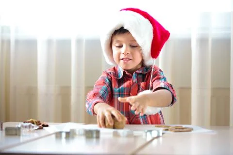 Little boy helping at kitchen with baking cookies Stock Photos