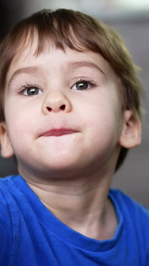 Little boy holding apple close to camera. Kid takes a bite from apples in both Stock Footage 333472601