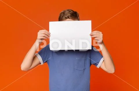 Little boy holding an blank card in front of his head Stock Photos