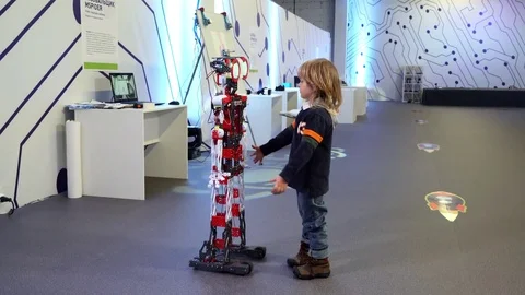 Little boy interacting with smart robot Stock Footage 73923694