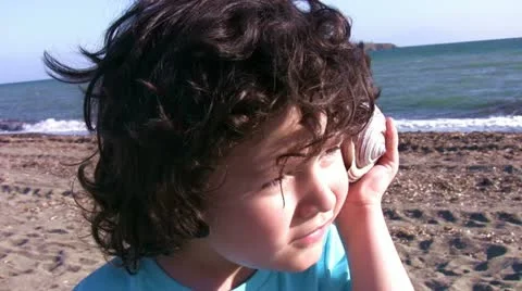 Little boy istenning to the seashell Video stock 11291165