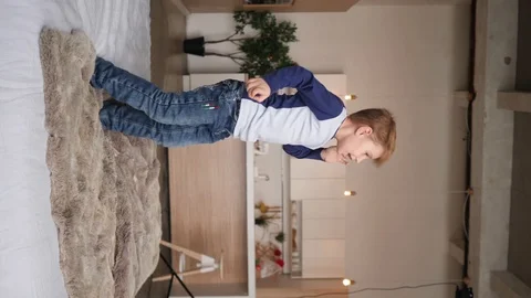 Little boy jumping on a bed Video stock 91823435
