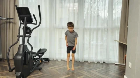 Little boy jumping forward and backward on both feet at home, Concept of child Vídeos de archivo 341865786