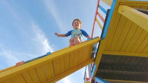 Little boy Jumping from the Slider Stock Footage 130095041