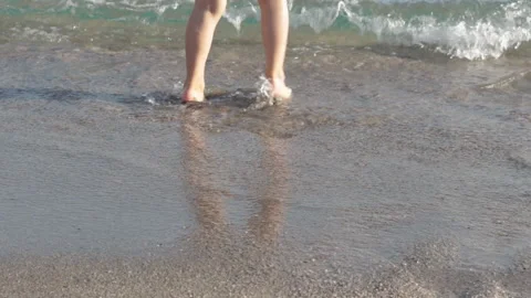 Little boy kid having fun in sea water running in or out jumping Video stock 218812336