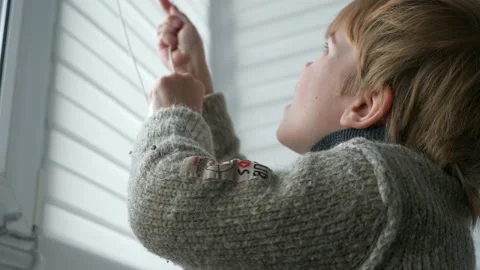 Little Boy Kid Opens Window Roller Shutter Blinds Curtain. Cute Child at Home 4K 库存影片 171656621