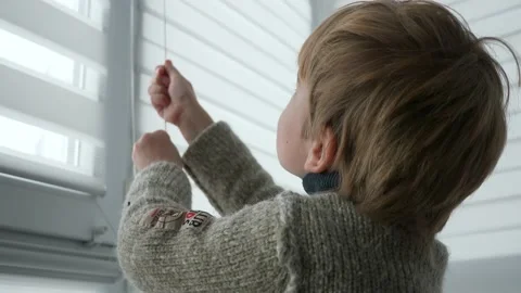 Little Boy Kid Opens Window Roller Shutter Blinds Curtain. Cute Child at Home 4K 库存影片 171656649
