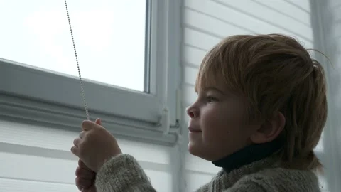 Little Boy Kid Opens Window Roller Shutter Blinds Curtain. Cute Child at Home 4K 库存影片 171656681