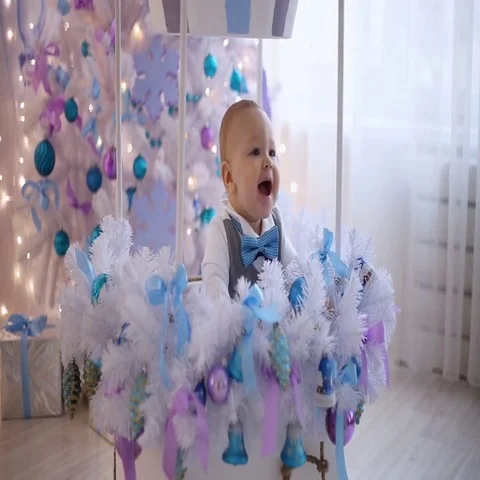 The little boy laughs at the Christmas tree Stock Footage 69412114