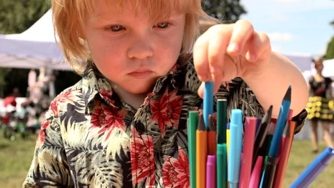 Little boy learning to draw outside on summer family festival. Children 스톡 동영상 114014262