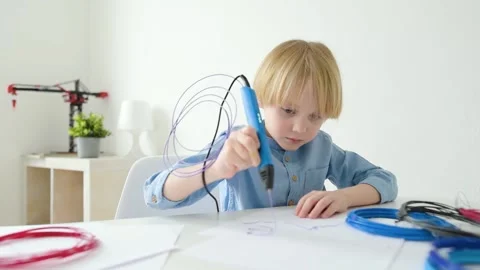 Little boy learning make model with 3d printing pen Stock Footage 149533821