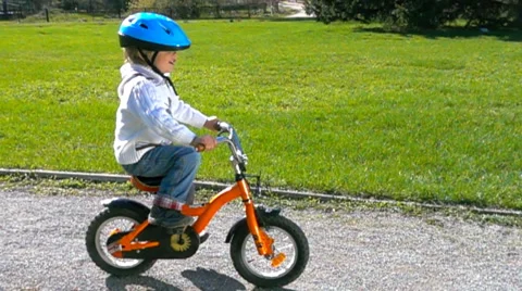 Little boy learning to ride a bike Stock Footage 62881174