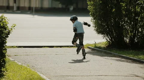 A little boy learning to roller skate Stock Footage 53431673