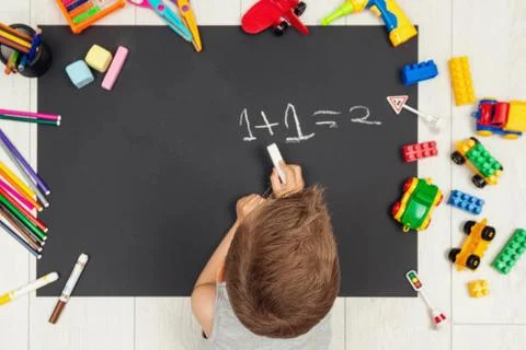 Little boy is learning simple arithmetic. adds one to one Stock Photos